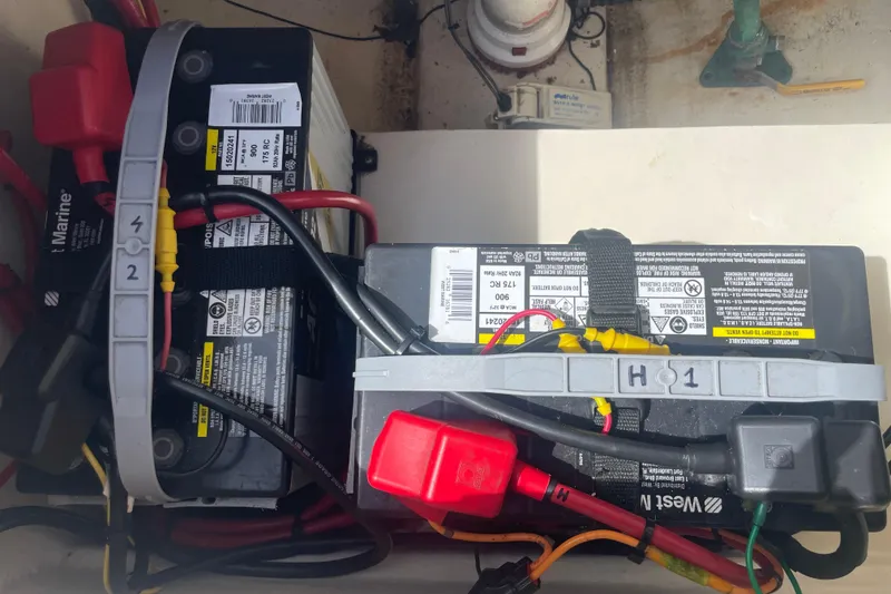Slide: The Image of Marine batteries in a 2008 Parker 2320 SL Sport Cabin boat, secured with straps and connected with cables. - 26