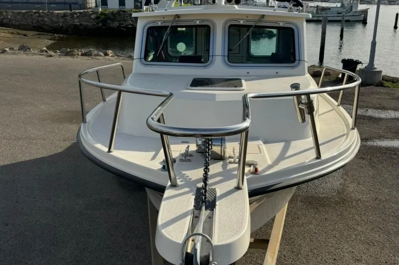 Slide: The Image of 2008 Parker 2320 SL Sport Cabin boat docked near a marina. - 3