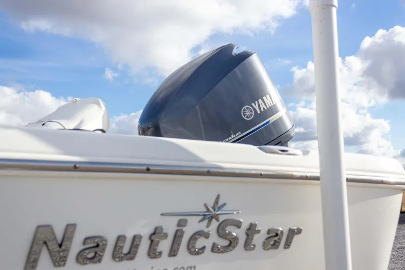 Slide: The Image of 2014 NauticStar 2400 Sport boat with Yamaha engine under a cloudy sky. - 12