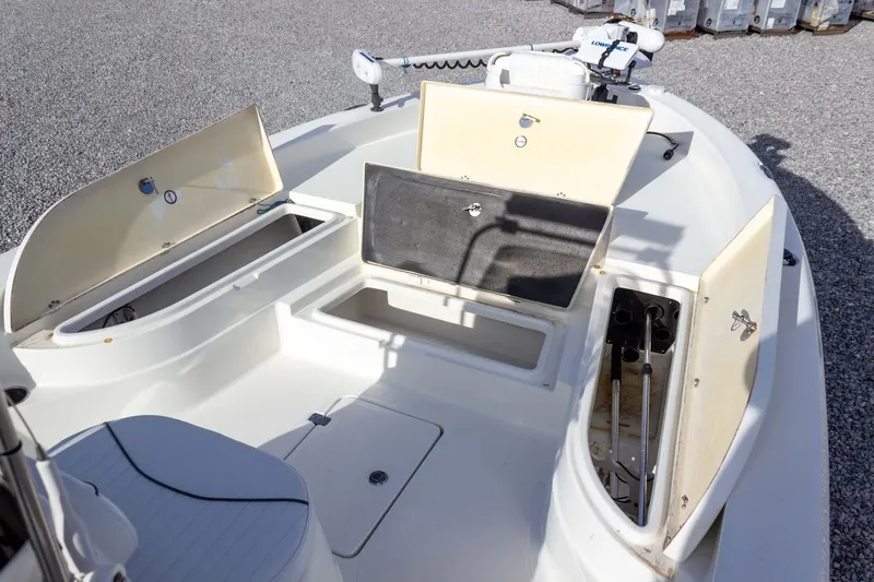 Slide: The Image of 2014 NauticStar 2400 Sport boat with open storage compartments on deck. - 14