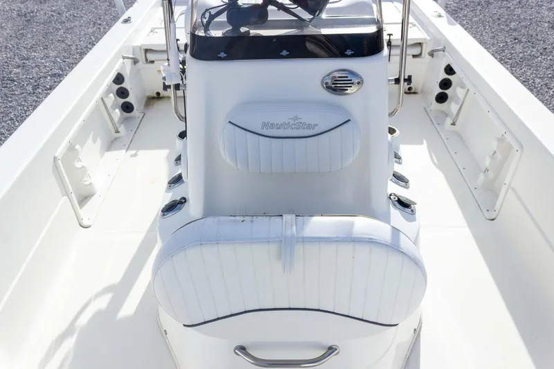 Slide: The Image of 2014 NauticStar 2400 Sport boat interior with white seating and console. - 19