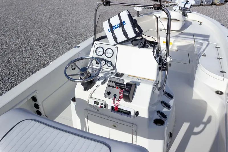 Slide: The Image of 2014 NauticStar 2400 Sport boat interior with steering console and navigation equipment. - 21