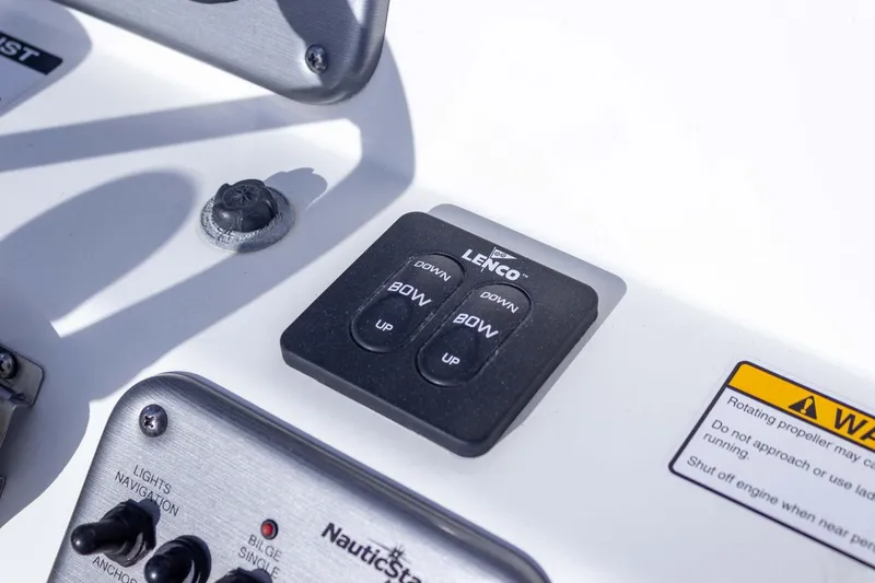 Slide: The Image of Control panel of 2014 NauticStar 2400 Sport boat with Lenco trim tab switches. - 24