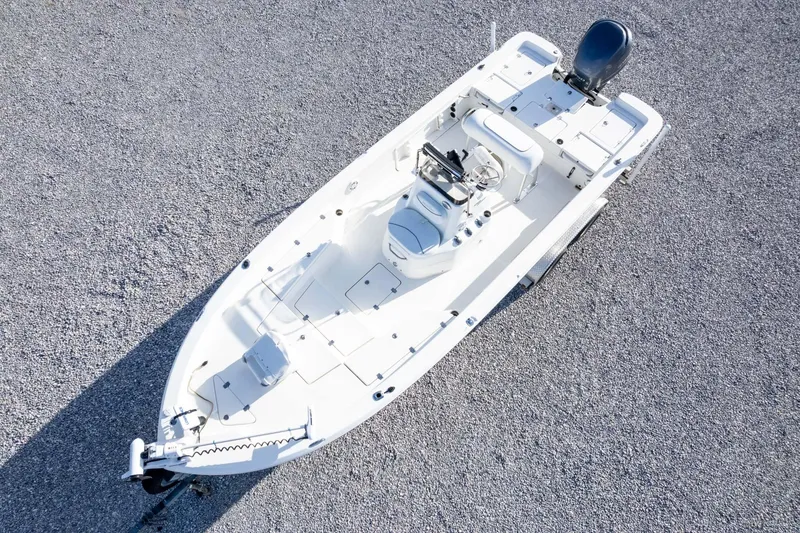 Slide: The Image of 2014 NauticStar 2400 Sport boat, aerial view on gravel surface. - 34