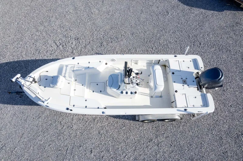 Slide: The Image of 2014 NauticStar 2400 Sport boat, aerial view on gravel surface. - 35
