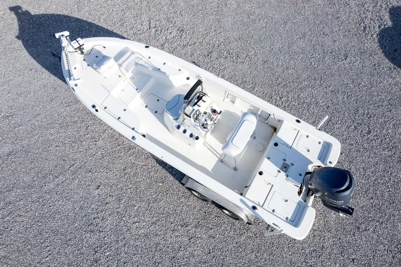 Slide: The Image of 2014 NauticStar 2400 Sport boat, aerial view on gravel surface. - 36