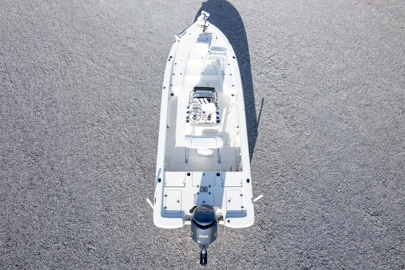 Slide: The Image of 2014 NauticStar 2400 Sport boat, aerial view on gravel surface. - 37