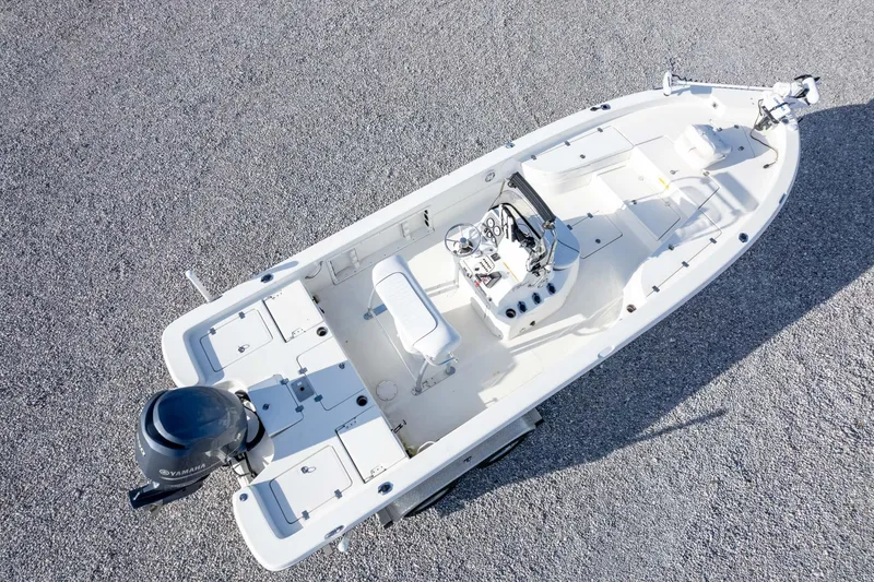 Slide: The Image of 2014 NauticStar 2400 Sport boat, aerial view, on gravel surface. - 38