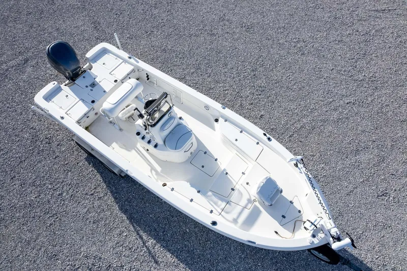 Slide: The Image of 2014 NauticStar 2400 Sport boat on gravel surface, aerial view. - 40