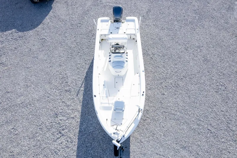 Slide: The Image of 2014 NauticStar 2400 Sport boat on gravel surface, aerial view. - 41