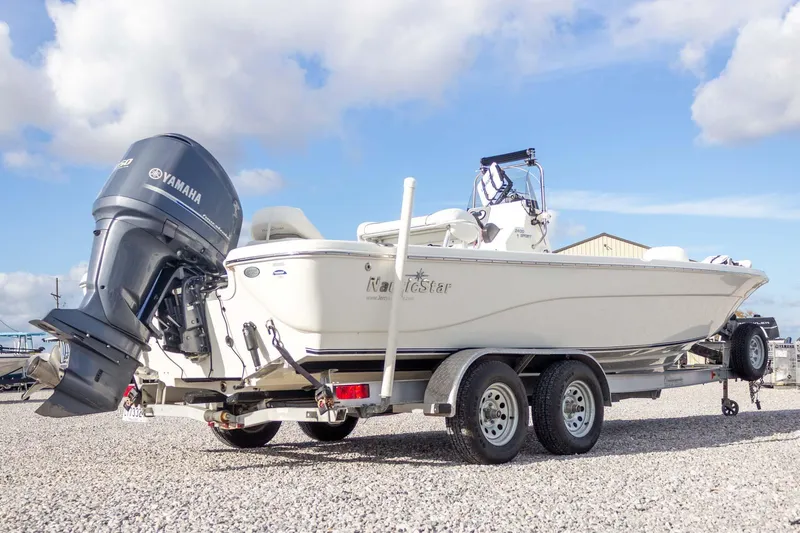 Slide: The Image of 2014 NauticStar 2400 Sport boat on trailer with Yamaha outboard motor. - 8