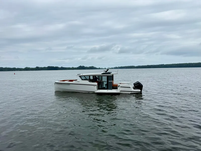 Slide: The Image of Saxdor 340 GTWA 2027 on calm water with modern design and outboard motor. - 23