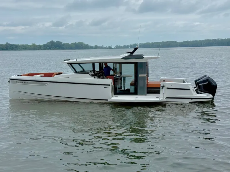 Slide: The Image of Saxdor 340 GTWA 2027 on calm water, featuring a sleek design and outboard motor. - 24