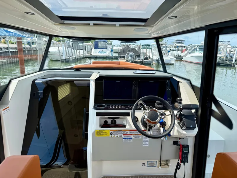 Slide: The Image of The 2027 Saxdor 340 GTWA cockpit features a modern helm with multiple screens. - 13