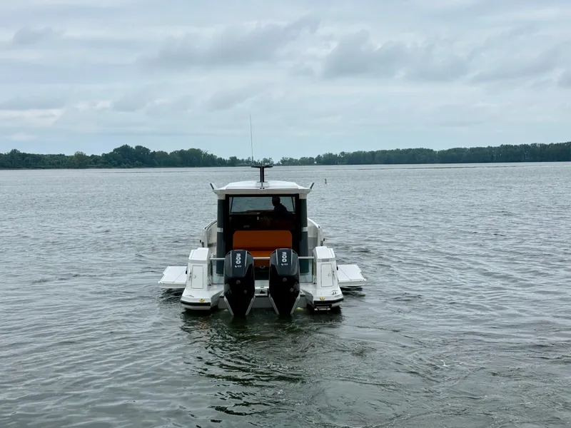 Slide: The Image of 2027 Saxdor 340 GTWA on calm water with twin outboard engines. - 22
