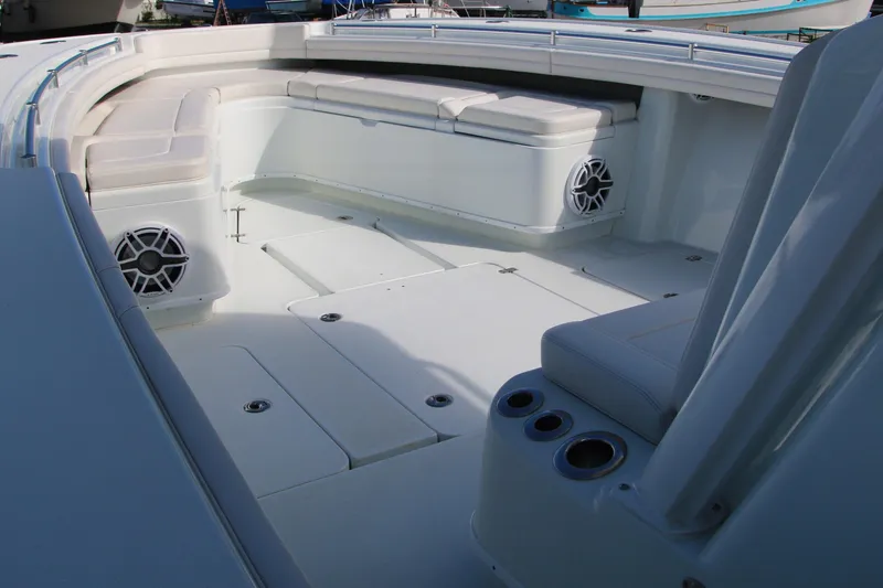 Slide: The Image of 2022 Yellowfin 39 Offshore boat interior with cushioned seating and speakers. - 11