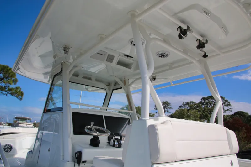 Slide: The Image of 2022 Yellowfin 39 Offshore boat interior with helm and seating under clear blue sky. - 14