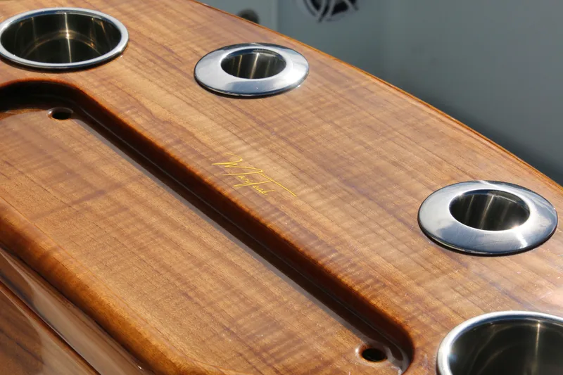 Slide: The Image of Wooden deck with stainless steel cup holders on a 2022 Yellowfin 39 Offshore boat. - 19