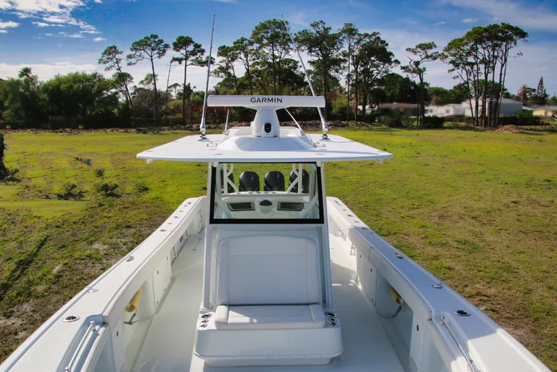 Slide: The Image of 2022 Yellowfin 39 Offshore boat on grassy terrain with clear sky background. - 20