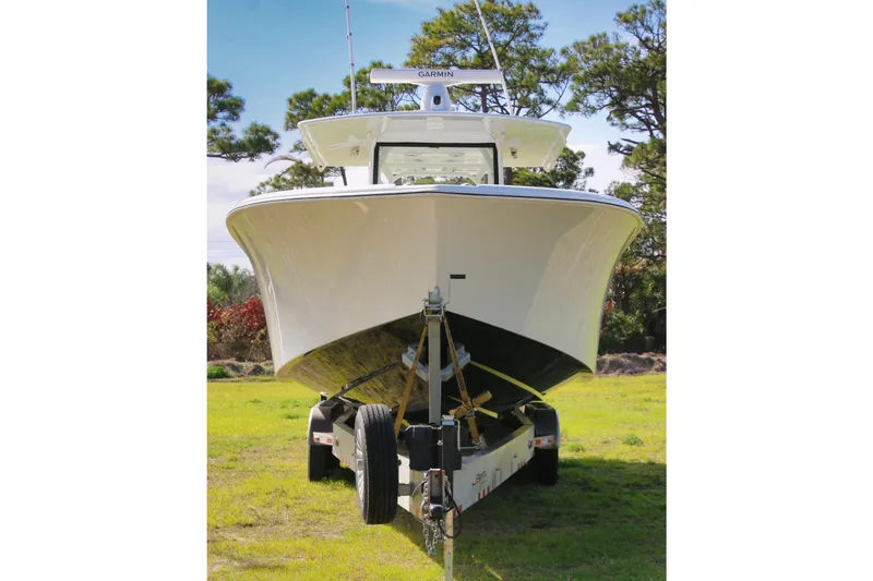 Slide: The Image of 2022 Yellowfin 39 Offshore boat on trailer, front view, parked on grass. - 23