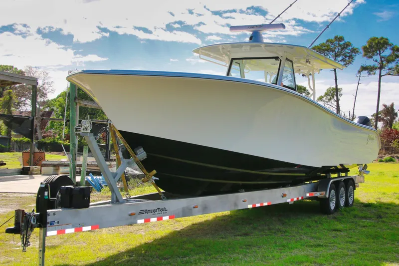 Slide: The Image of 2022 Yellowfin 39 Offshore boat on trailer, parked outdoors under a clear sky. - 25