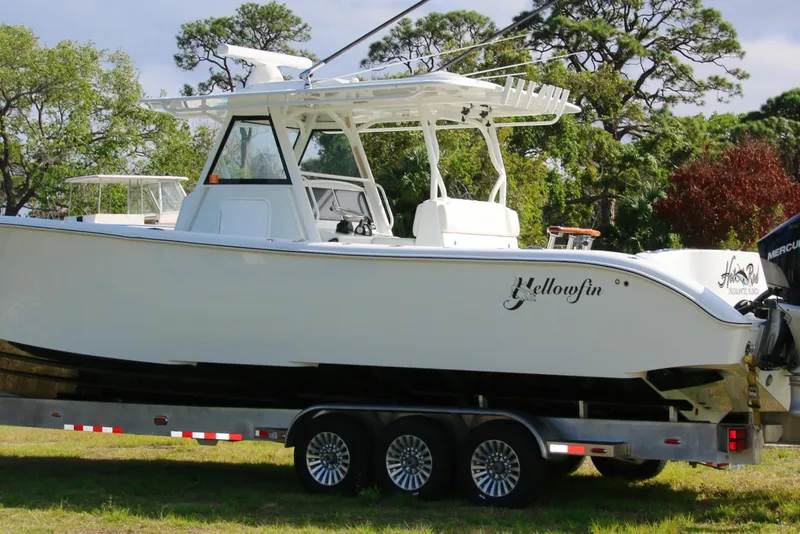 Slide: The Image of 2022 Yellowfin 39 Offshore boat on trailer, surrounded by trees. - 26