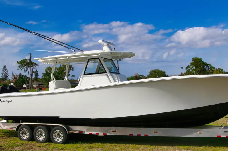 Slide: The Image of 2022 Yellowfin 39 Offshore boat on trailer under blue sky. - 33