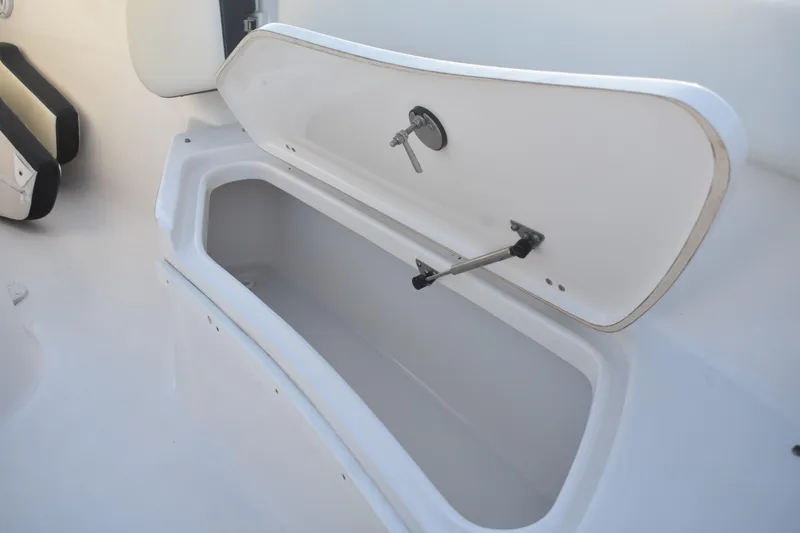 Slide: The Image of Open storage compartment on 2021 Tidewater 232 LXF boat, showcasing interior space. - 15