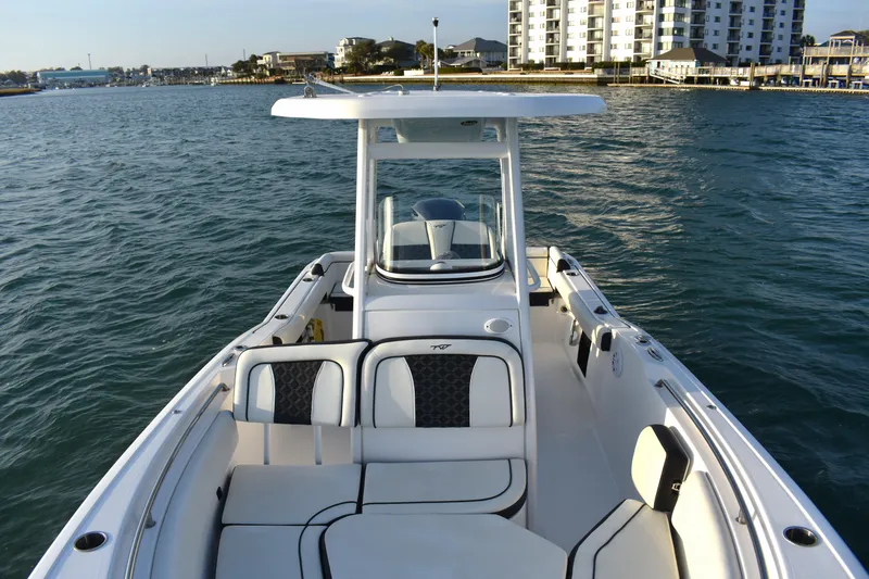 Slide: The Image of 2021 Tidewater 232 LXF boat on water near coastal buildings. - 9