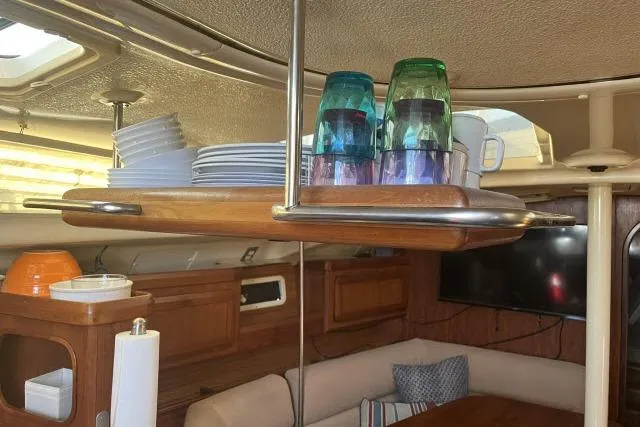 Slide: The Image of Interior of 1995 Hunter Legend 40.5 yacht with dining area and dish storage. - 10