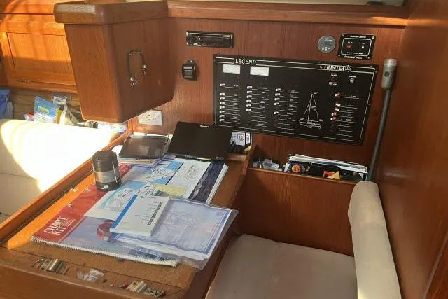 Slide: The Image of Navigation station of 1995 Hunter Legend 40.5 sailboat with charts and instruments. - 11