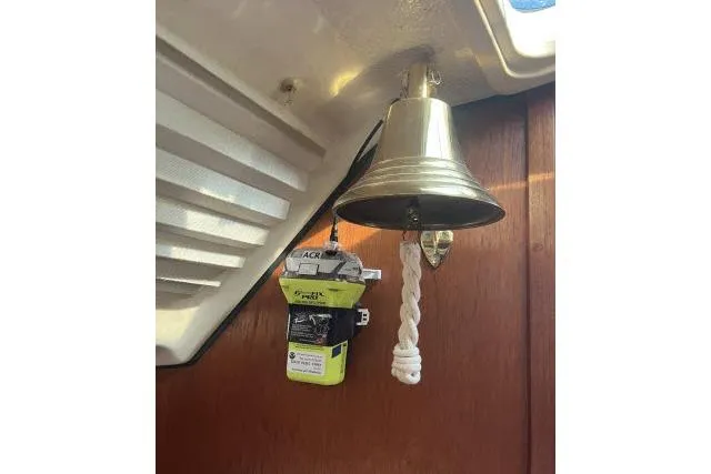 Slide: The Image of Brass bell and emergency equipment inside 1995 Hunter Legend 40.5 sailboat cabin. - 12