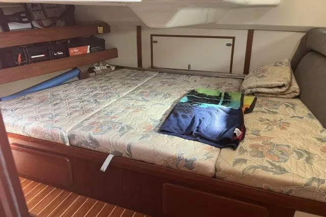Slide: The Image of Interior cabin of 1995 Hunter Legend 40.5 sailboat with floral-patterned bedding. - 13