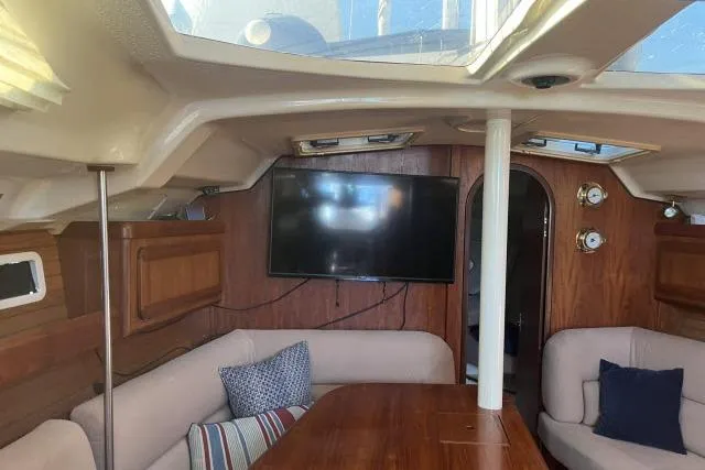 Slide: The Image of Interior of 1995 Hunter Legend 40.5 yacht with cozy seating and mounted TV. - 2