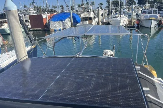 Slide: The Image of 1995 Hunter Legend 40.5 sailboat with solar panels in a marina setting. - 20