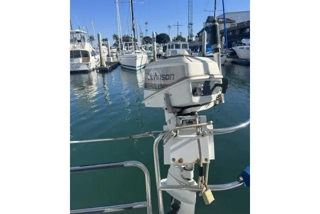 Slide: The Image of Outboard motor on a 1995 Hunter Legend 40.5 sailboat docked in a marina. - 21
