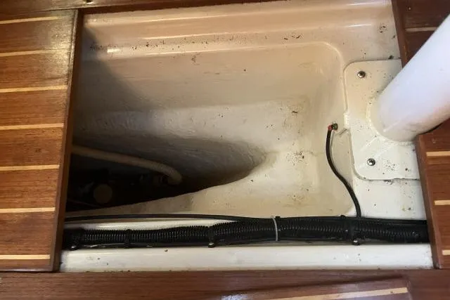 Slide: The Image of Interior view of a 1995 Hunter Legend 40.5 sailboat, showcasing a storage compartment. - 27