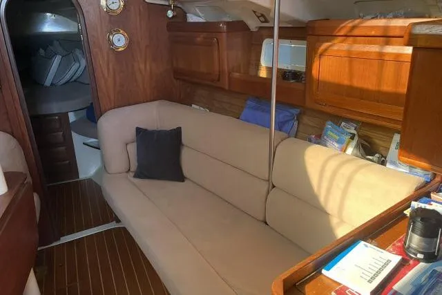 Slide: The Image of Interior of 1995 Hunter Legend 40.5 yacht with cozy seating and wooden cabinetry. - 4