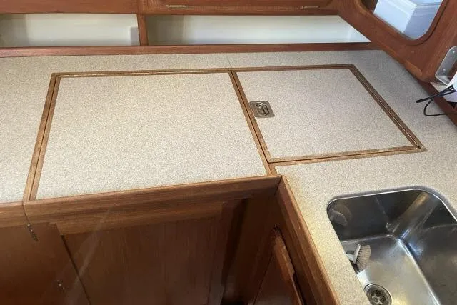 Slide: The Image of 1995 Hunter Legend 40.5 yacht kitchen with wooden cabinetry and stainless steel sink. - 6