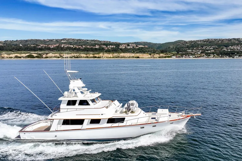 Slide: The Image of 1970 Hargrave Yachtfisher cruising on open water with scenic coastal backdrop. - 14