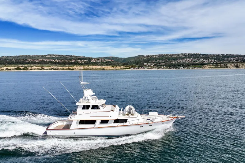 Slide: The Image of 1970 Hargrave Yachtfisher cruising on open water with scenic coastal backdrop. - 15
