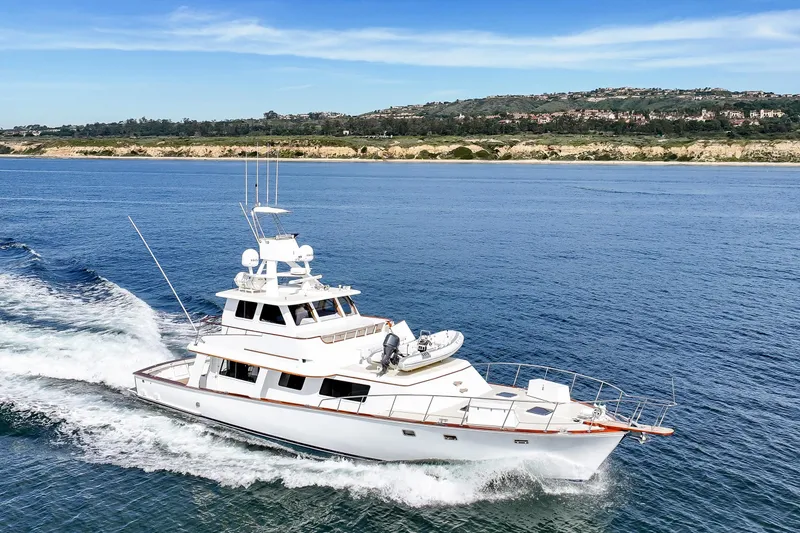 Slide: The Image of 1970 Hargrave Yachtfisher cruising on open water with scenic coastline backdrop. - 16