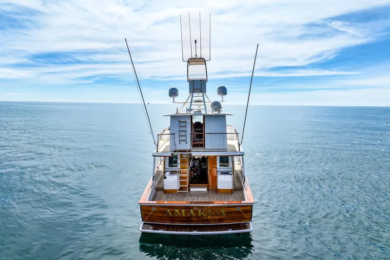 Slide: The Image of 1970 Hargrave Yachtfisher on open sea under blue sky, rear view. - 2
