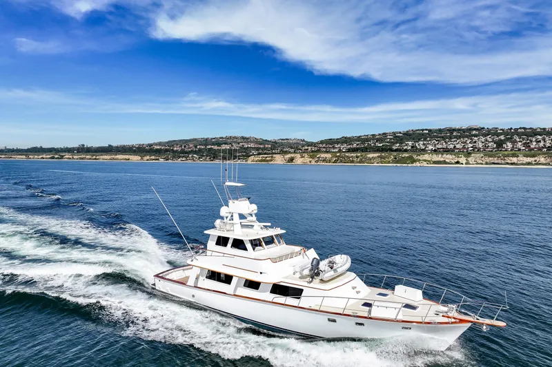 Slide: The Image of 1970 Hargrave Yachtfisher cruising on blue ocean near scenic coastline. - 22