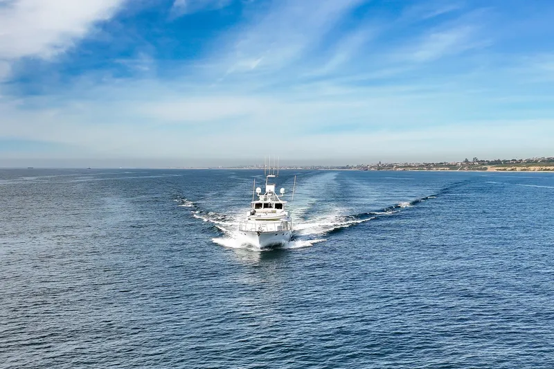 Slide: The Image of 1970 Hargrave Yachtfisher cruising on open sea under clear blue sky. - 23