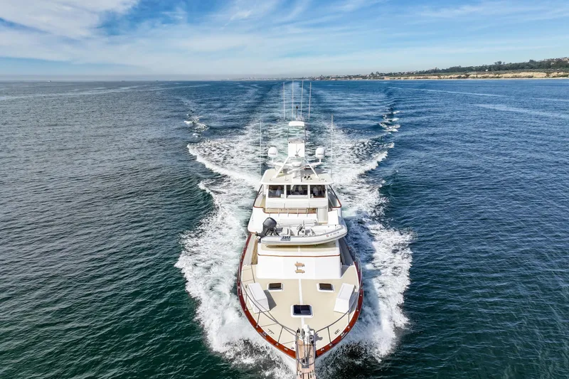 Slide: The Image of 1970 Hargrave Yachtfisher cruising on open water under a clear blue sky. - 24