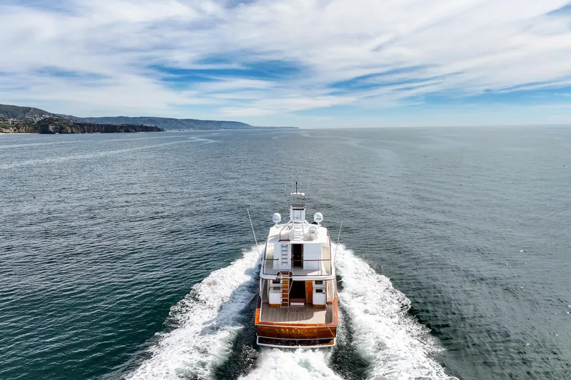 Slide: The Image of 1970 Hargrave Yachtfisher cruising on open sea under a partly cloudy sky. - 25