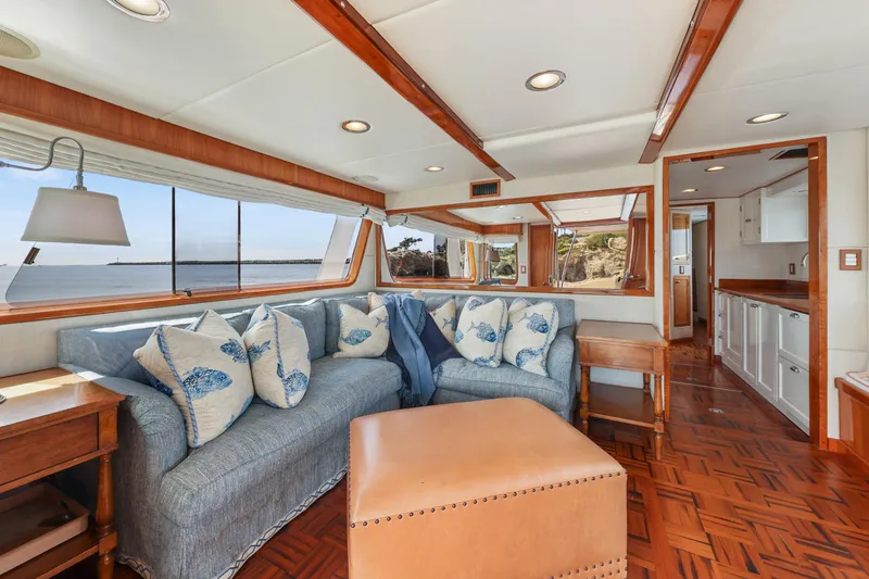 Slide: The Image of Luxurious 1970 Hargrave Yachtfisher interior with ocean view, featuring elegant seating and wooden accents. - 26