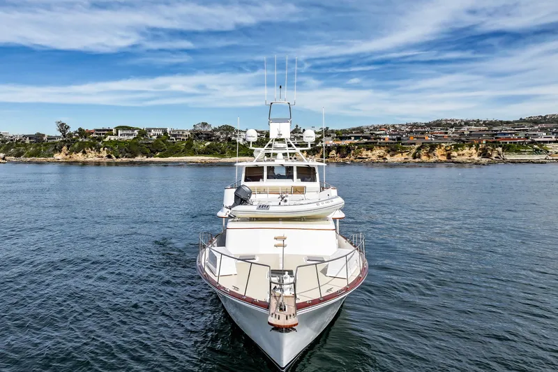 Slide: The Image of 1970 Hargrave Yachtfisher on calm waters with scenic coastal background. - 4