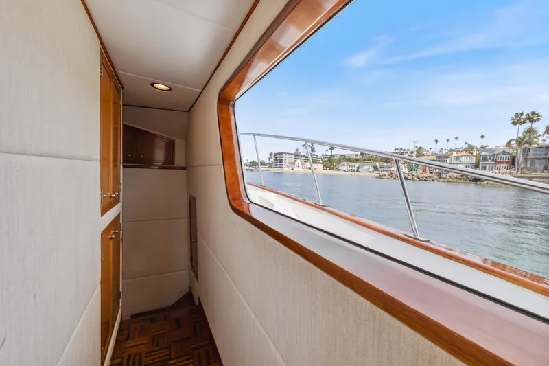 Slide: The Image of Interior view of 1970 Hargrave Yachtfisher, showcasing elegant wood finishes and scenic waterway. - 43